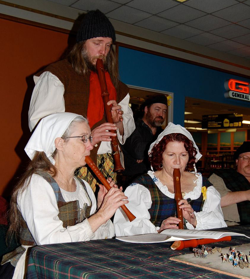 three members playing recorders